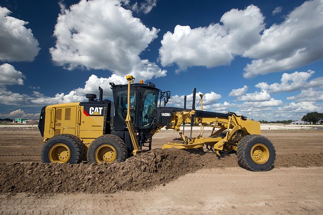 CAT motor grader preparing an industrial project site