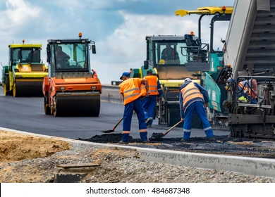 Road rollers and paving equipment on a highway construction site